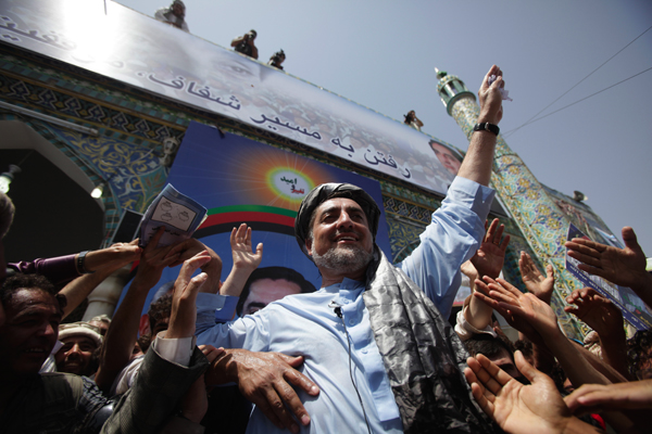 Afghan presidential candidate Abdullah Abdullah waves to the crowd as he gives a campaign speech outside The Blue Mosque in Mazar-i-Sharif in Balkh province