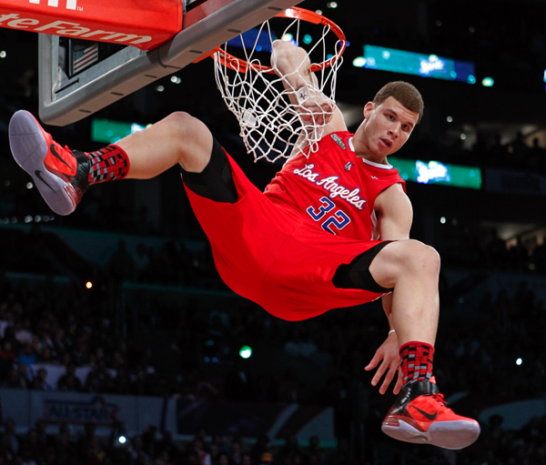 Los Angeles Clippers' Blake Griffin hangs on the rim while competing in the slam dunk contest during the NBA All-Star dunk contest in Los Angeles.