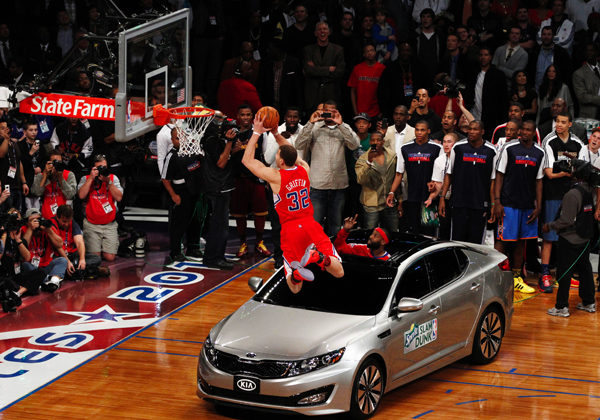 Clippers' Blake Griffin jumps over a car while competing in the slam dunk contest during the NBA All-Star weekend in Los Angeles