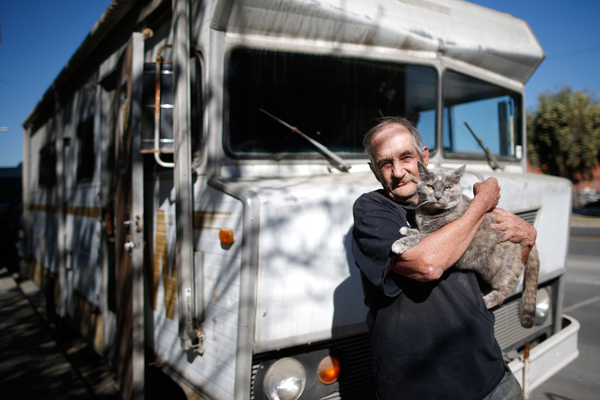 Dan, 68, holds one of his three cats as he poses for a portrait by the RV in which he lives on the streets of Los Angeles, California, United States, November 12, 2015. Dan has been homeless for over a decade. He bought the RV from a couple who helped him out by selling it for $1. Los Angeles officials in September declared the rising problem of homelessness an "emergency" in the city and proposed spending $100 million to provide permanent housing and shelters to help the city's 26,000 indigent. The nation's second-largest city has nearly 18,000 individuals living on the streets, as opposed to shelters. REUTERS/Lucy Nicholson
