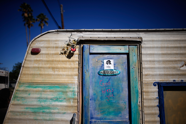 A welcome sign is seen on the door of a caravan in a homeless RV and tent encampment near LAX airport in Los Angeles, California, United States, October 26, 2015. Los Angeles officials last month declared the rising problem of homelessness an "emergency" in the city and proposed spending $100 million to provide permanent housing and shelters to help the city's 26,000 indigent. The nation's second-largest city has nearly 18,000 individuals living on the streets, as opposed to shelters. REUTERS/Lucy Nicholson