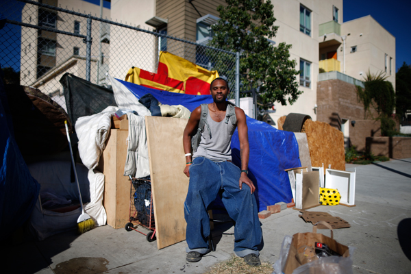 Dontray Williams, 28, poses for a portrait by the tent in which he lives on the streets of Los Angeles, California, United States, November 13, 2015. Williams has been homeless for around five years. Los Angeles officials in September declared the rising problem of homelessness an "emergency" in the city and proposed spending $100 million to provide permanent housing and shelters to help the city's 26,000 indigent. The nation's second-largest city has nearly 18,000 individuals living on the streets, as opposed to shelters. REUTERS/Lucy Nicholson