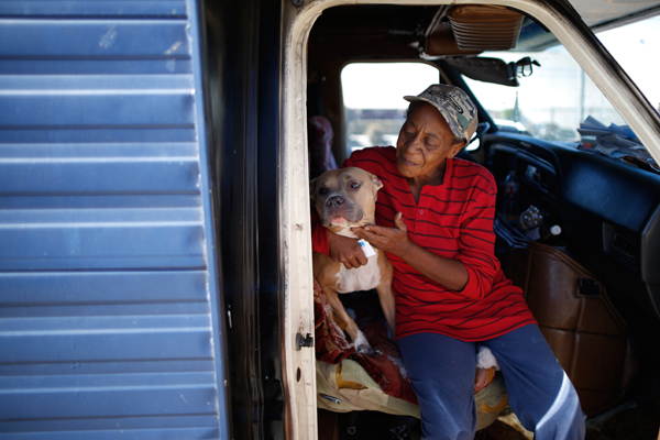 Pamela Polk, 56, hugs her dog inside the RV in which she lives on the streets of Los Angeles, California, United States, November 12, 2015. Polk became homeless four months ago when she was evicted from her apartment, and had to borrow money from a friend to buy the RV. Los Angeles officials in September declared the rising problem of homelessness an "emergency" in the city and proposed spending $100 million to provide permanent housing and shelters to help the city's 26,000 indigent. The nation's second-largest city has nearly 18,000 individuals living on the streets, as opposed to shelters. REUTERS/Lucy Nicholson