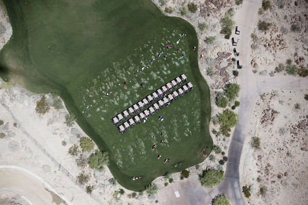People play golf on a course in La Quinta, California April 13, 2015. California's cities and towns would be required to cut their water usage by up to 35 percent or face steep fines under proposed new rules, the state's first-ever mandatory cutbacks in urban water use as the state enters its fourth year of severe drought. Communities where residential customers use more than 165 gallons of water per person per day would have to cut back by 35 percent. Picture taken April 13, 2015. REUTERS/Lucy Nicholson - RTR4XD6C